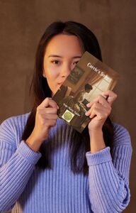 Woman holding a copy of Carrie's Song